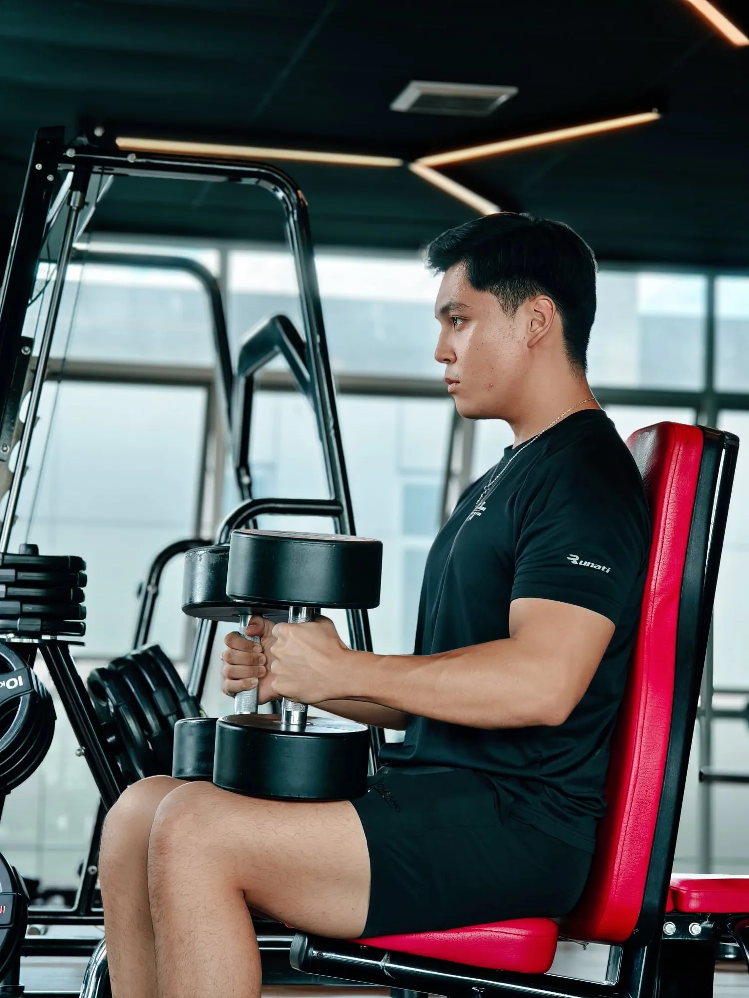 Seated dumbbell curl beside the window