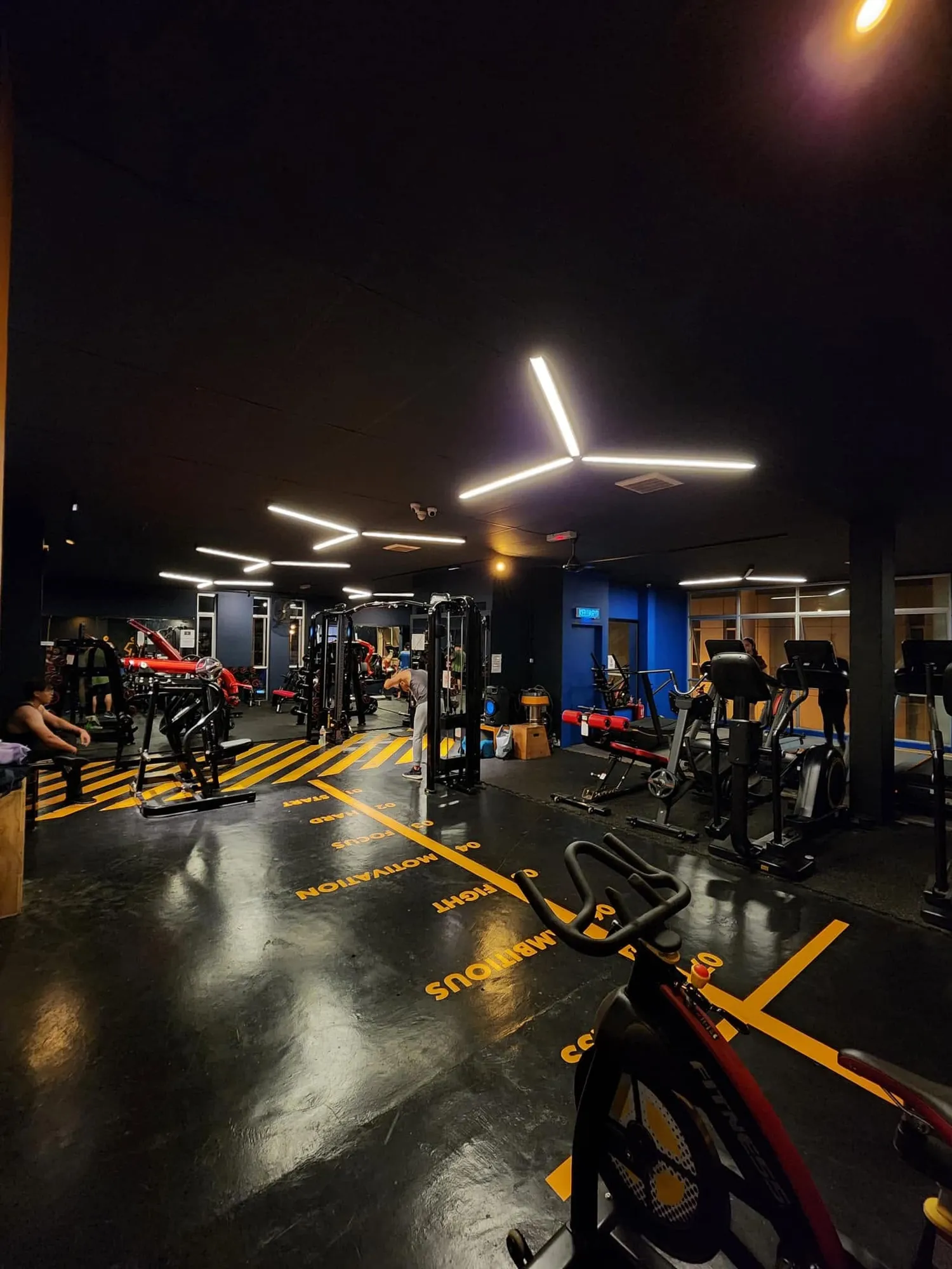 The main floor at night, lit by the ceiling strips
