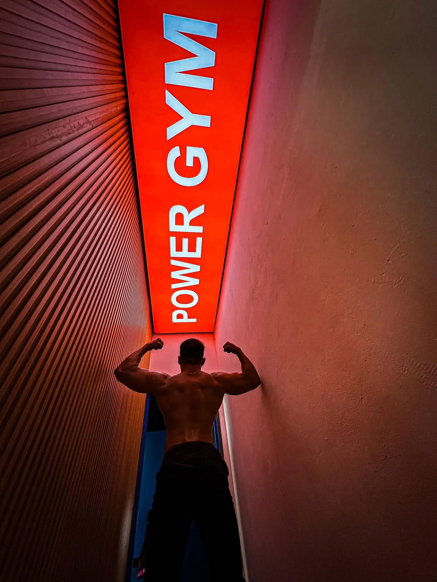 The lit POWER GYM sign above the entrance stairwell